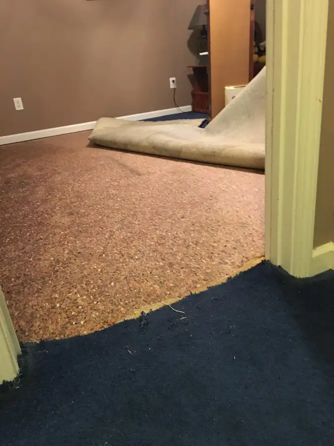 Carpet pad removal revealing water damage during Water Mitigation Services in Nacogdoches