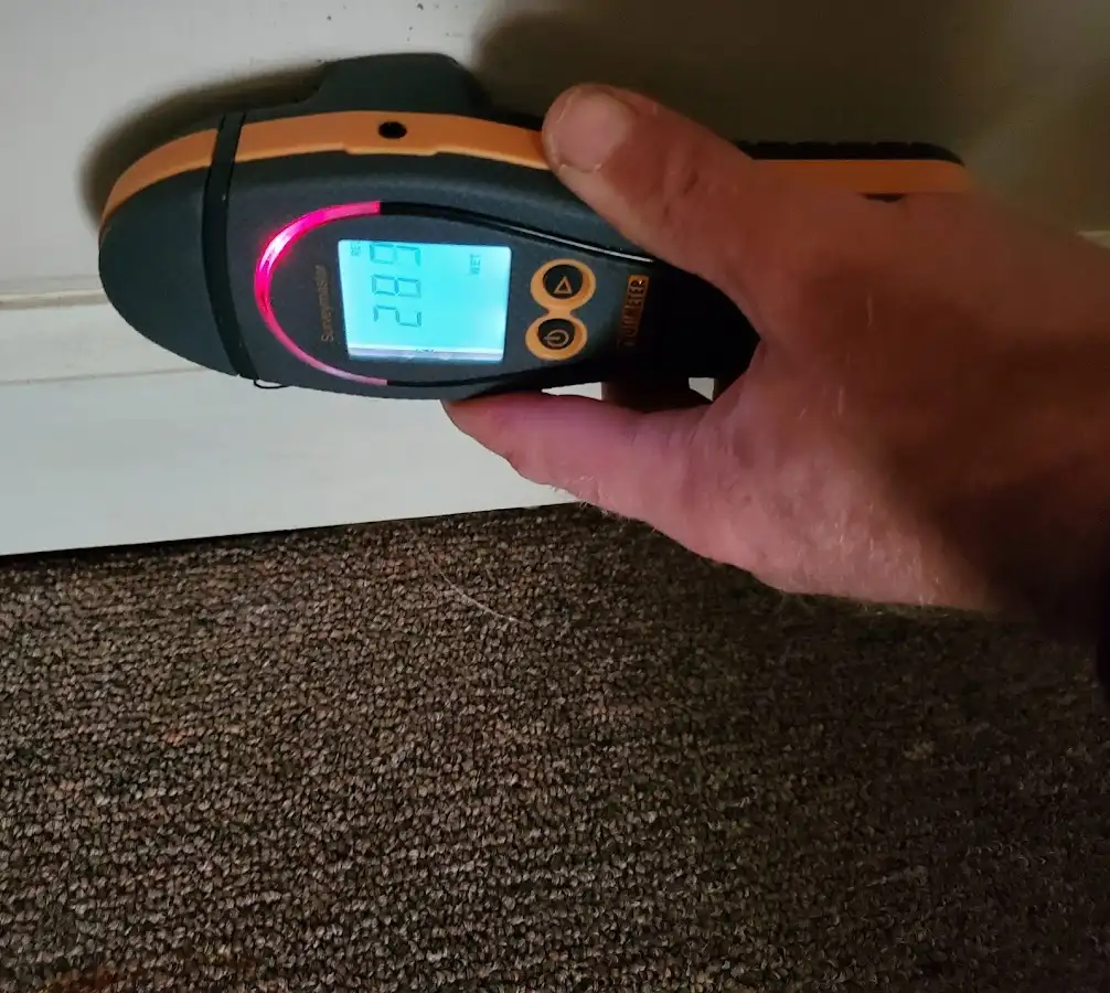Moisture detection at baseboard during Storm Damage Restoration in Nacogdoches